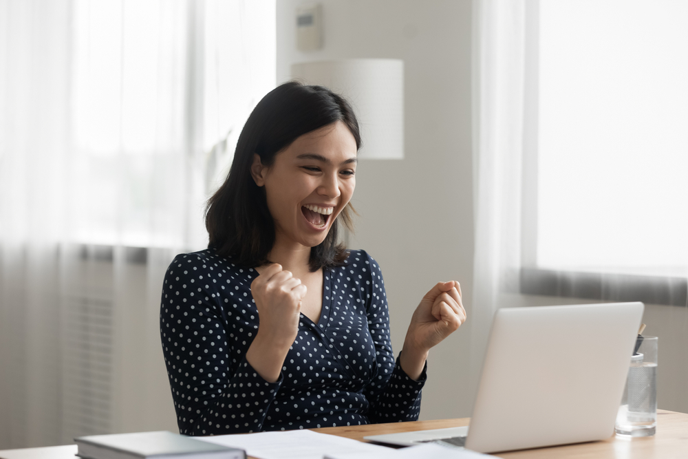 Excited,Young,Vietnamese,Woman,Look,At,Laptop,Pc,Screen,In